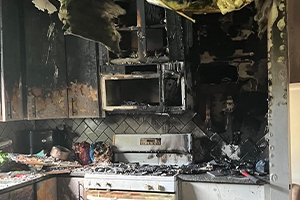 Smoke damage restoration team cleaning air ducts and walls in a Denver home