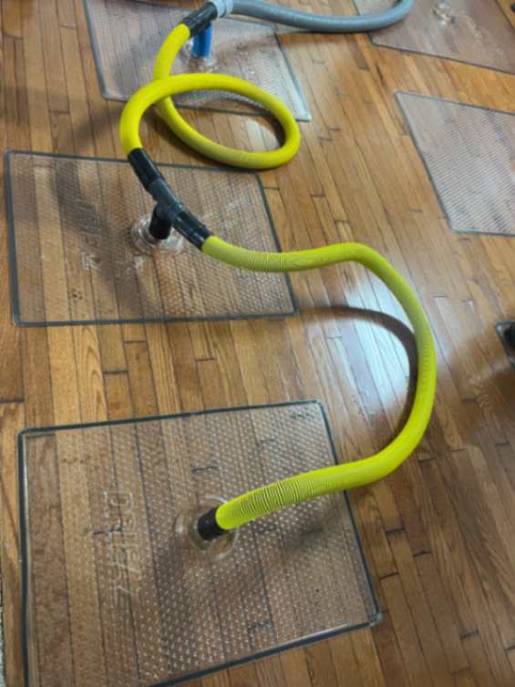 Technicians using drying fans and dehumidifiers to restore a flooded living room in Aurora, Colorado